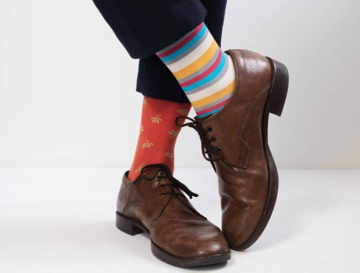 men's feet in stylish shoes and funny socks
