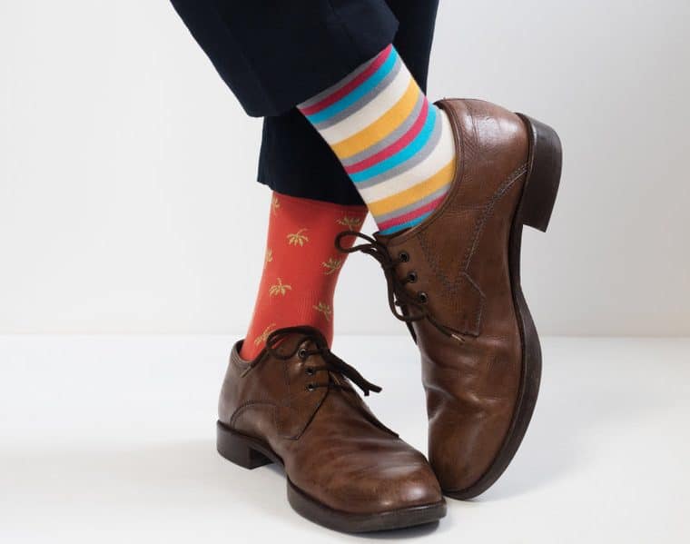 men's feet in stylish shoes and funny socks