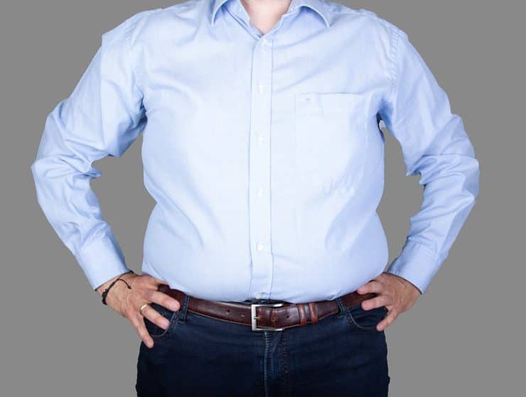 man with a big belly wearing a shirt and jeans