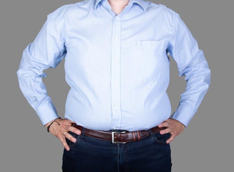 man with a big belly wearing a shirt and jeans